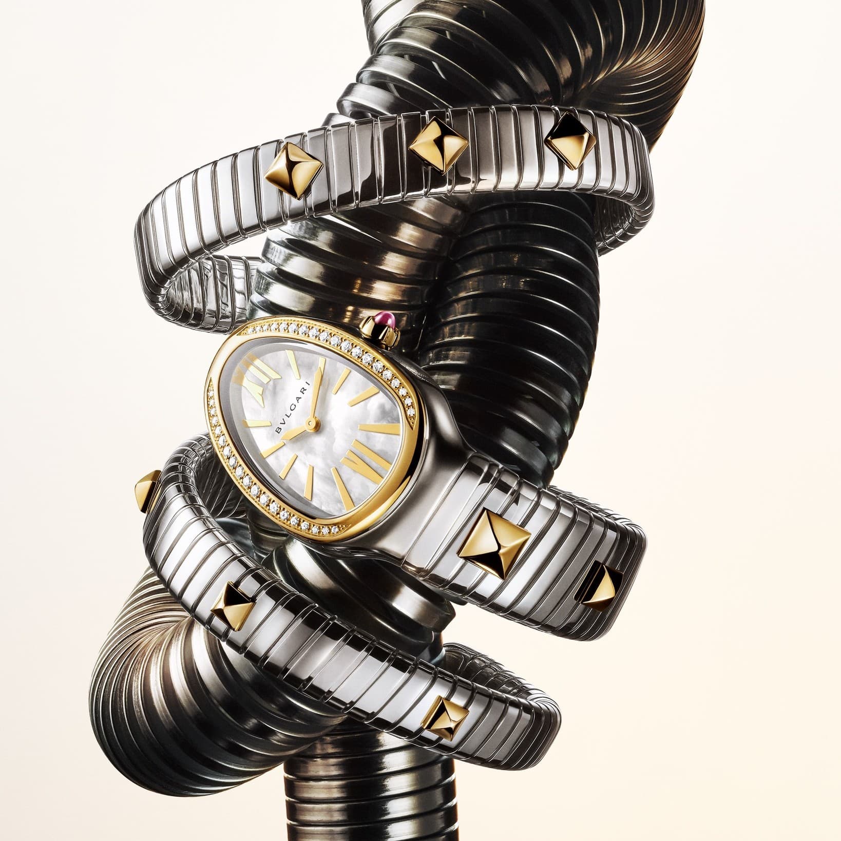 Bulgari Serpenti Tubogas watch coiled in steel with yellow-gold studs and a mother-of-pearl dial